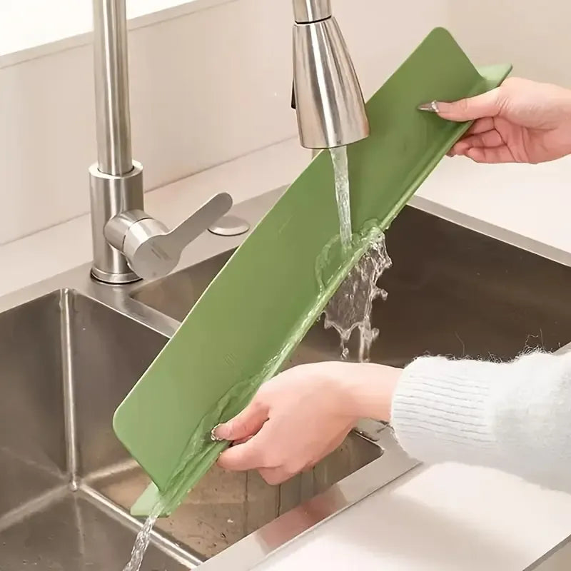 Person washing a green cutting board under running water in a kitchen sink, highlighting its easy-to-clean, waterproof, and reusable design for everyday food preparation.