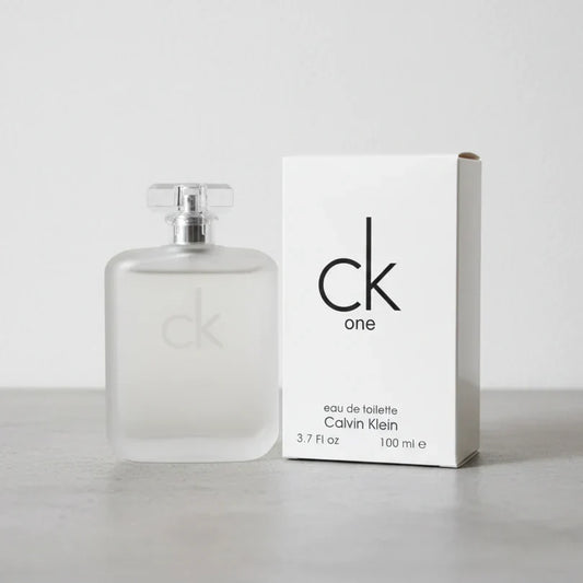 Calvin Klein CK One Eau de Toilette perfume bottle and packaging displayed on a light gray background, featuring a sleek minimalist design and a fresh unisex fragrance presentation.