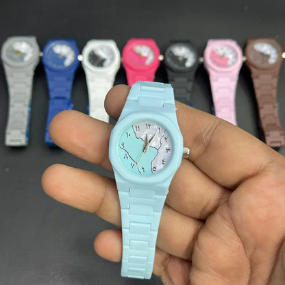 Close-up of a sky blue analog wristwatch with a matching strap and elegant artistic dial design. The watch is displayed in hand with multiple color options in the background, making it a stylish everyday accessory for women and girls.