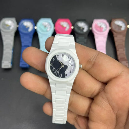 Close-up of a white women's wrist watch featuring a black and white marble pattern dial, silver hands, and a matching silicone strap, with multiple color variants displayed in the background.