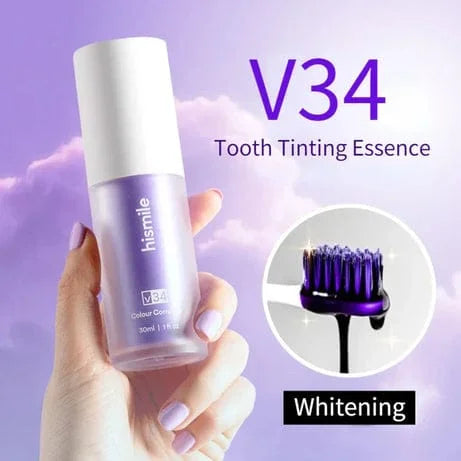 Hismile V34 tooth tinting essence bottle held bHismile V34 tooth tinting essence bottle held by a hand against a purple background. Showcases a dental whitening care product designed to improve the appearance of tooth color, enhance brightness, and support a fresh-looking smile.y a hand with a purple background